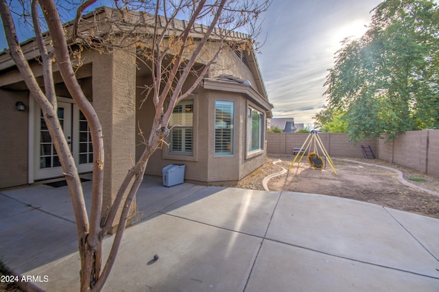 back house at dusk with a patio