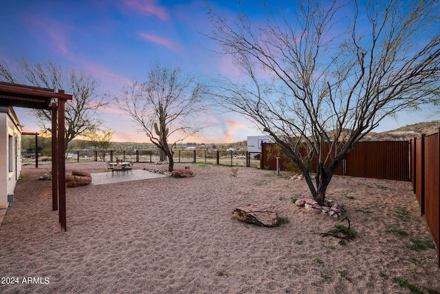 view of yard at dusk