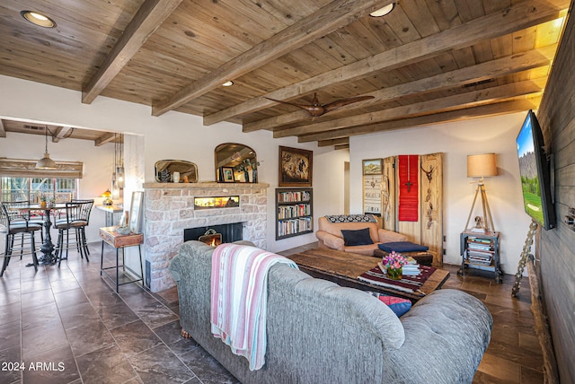 tiled living room featuring wood ceiling, beam ceiling, and a stone fireplace