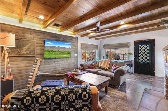 living room featuring beamed ceiling, wood ceiling, ceiling fan, and tile patterned floors