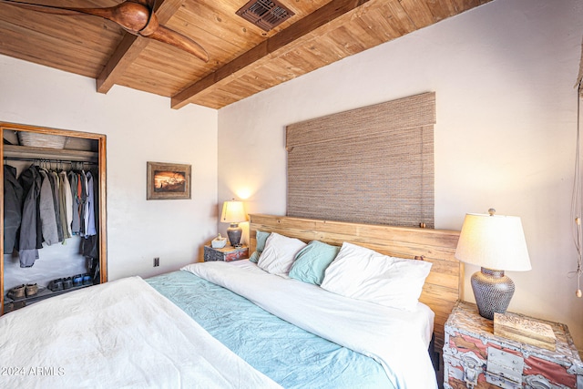 bedroom with a closet, beamed ceiling, and wood ceiling