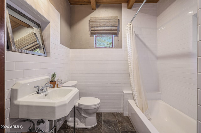 bathroom featuring shower / bath combo, toilet, tile patterned flooring, and tile walls