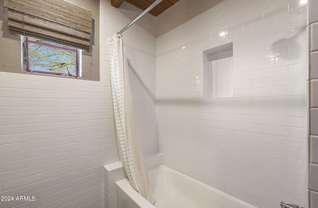 bathroom with shower / bath combination with curtain