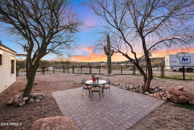 view of patio terrace at dusk