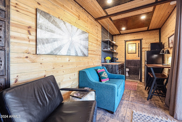 living area featuring wooden walls, dark hardwood / wood-style floors, and wood ceiling