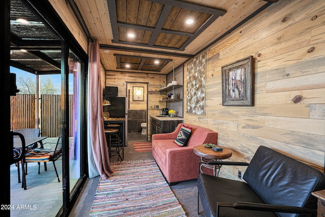 living area with wood walls, dark hardwood / wood-style floors, and wood ceiling