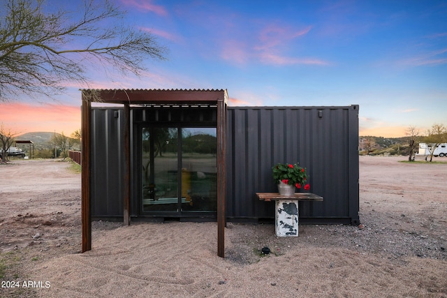 view of outdoor structure at dusk