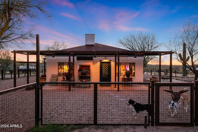 view of back house at dusk