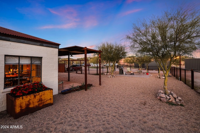 yard at dusk featuring a patio area