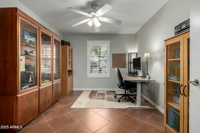 office with ceiling fan, baseboards, and dark tile patterned flooring