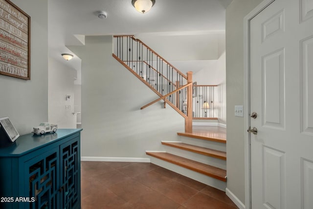 stairway with tile patterned flooring and baseboards