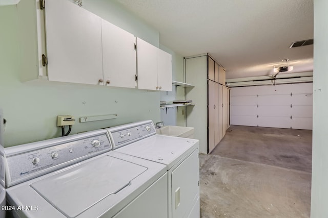 washroom with cabinets, separate washer and dryer, and sink