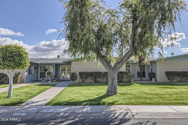 ranch-style home featuring a front yard