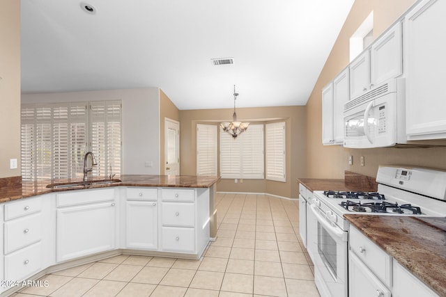 kitchen with a chandelier, white appliances, vaulted ceiling, sink, and white cabinets