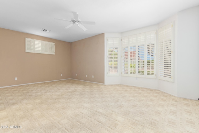 unfurnished room with ceiling fan and light carpet