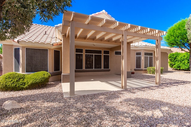 back of house with a pergola and a patio area