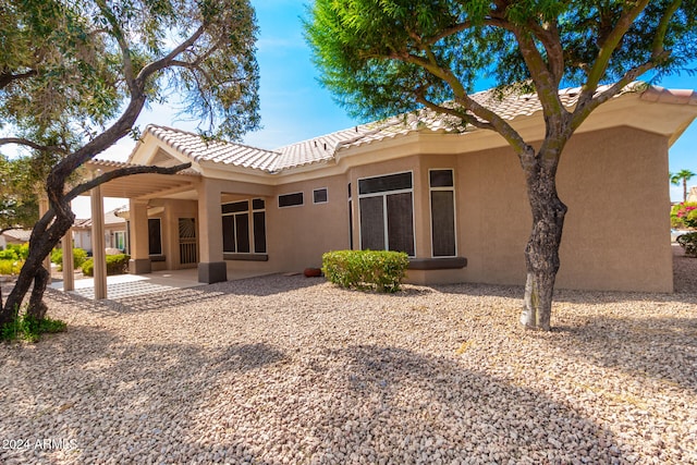 rear view of property featuring a patio