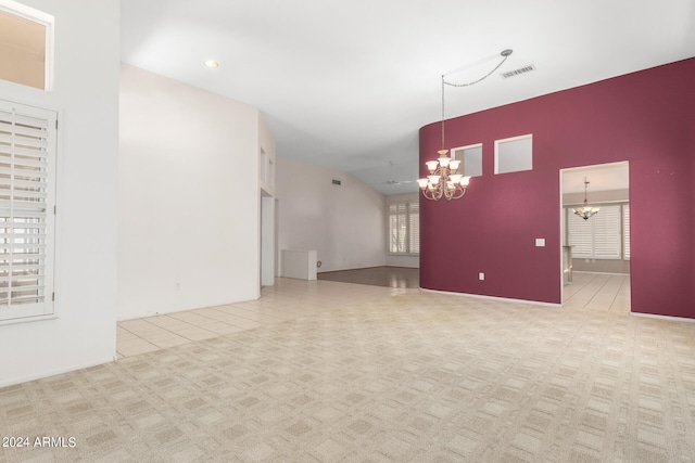 unfurnished room with light tile patterned flooring and an inviting chandelier