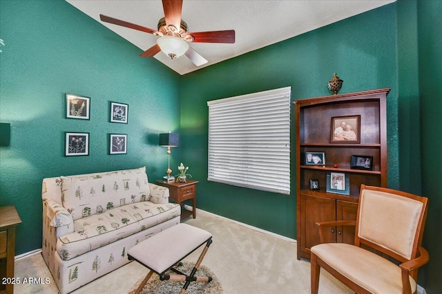 sitting room with carpet, a ceiling fan, and baseboards