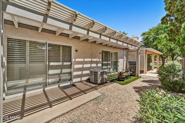 view of patio featuring central AC unit and a pergola