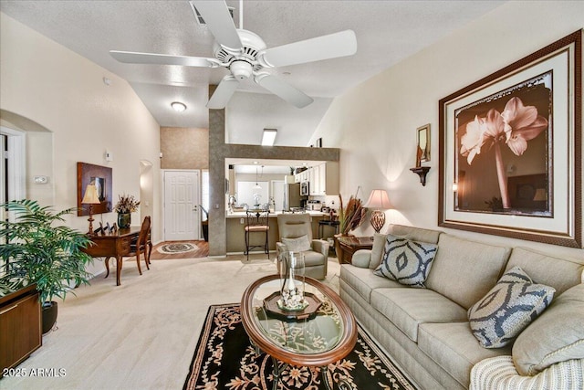 living room with light colored carpet, lofted ceiling, and ceiling fan