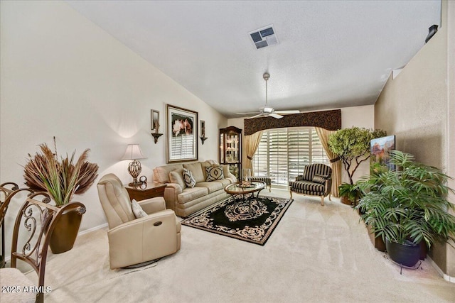 living area with carpet floors, ceiling fan, and lofted ceiling