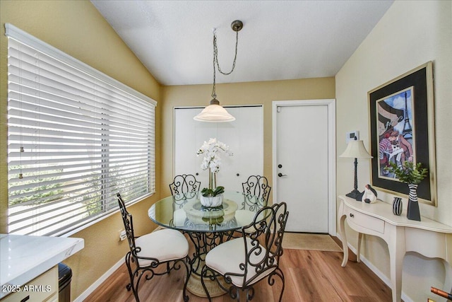 dining space featuring wood finished floors and baseboards
