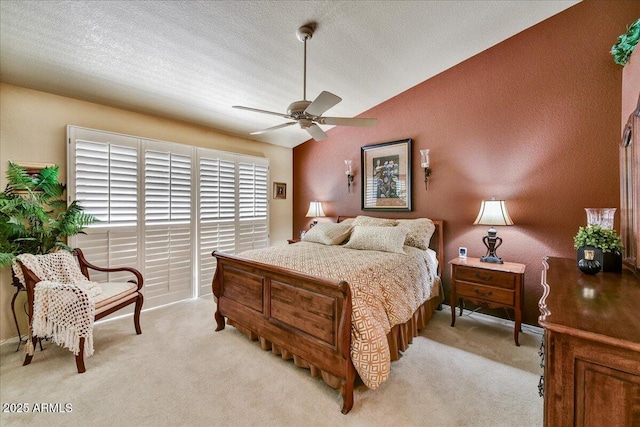 bedroom featuring light carpet, ceiling fan, a textured ceiling, and baseboards