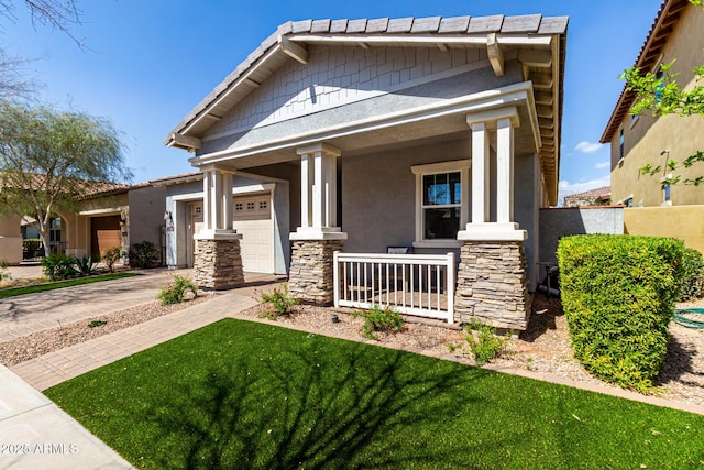 view of front of property with covered porch, stucco siding, concrete driveway, a garage, and stone siding