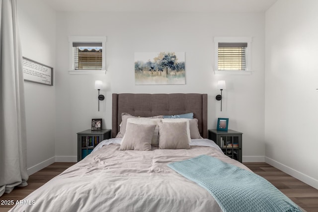 bedroom with wood finished floors and baseboards