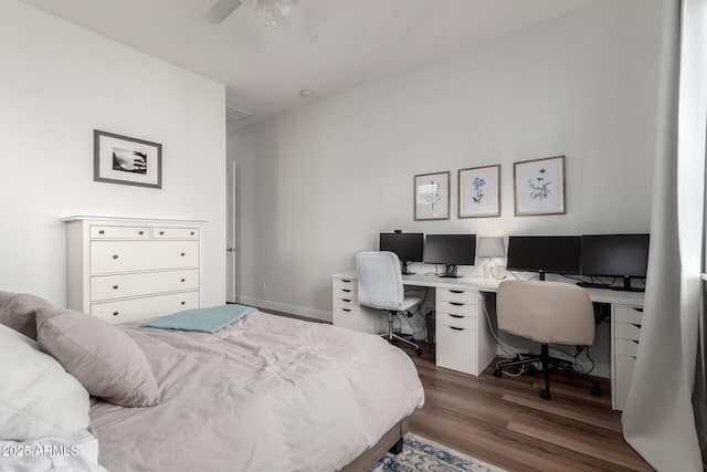 bedroom with a ceiling fan and wood finished floors