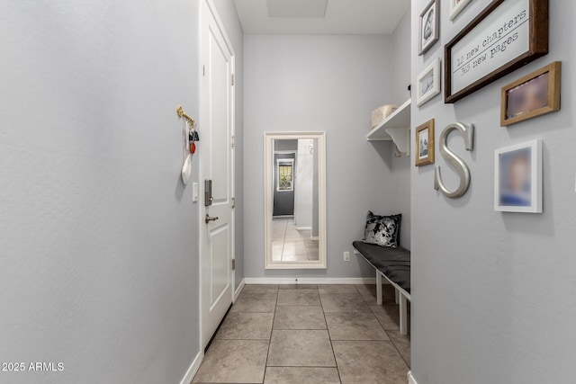 mudroom with baseboards and tile patterned flooring