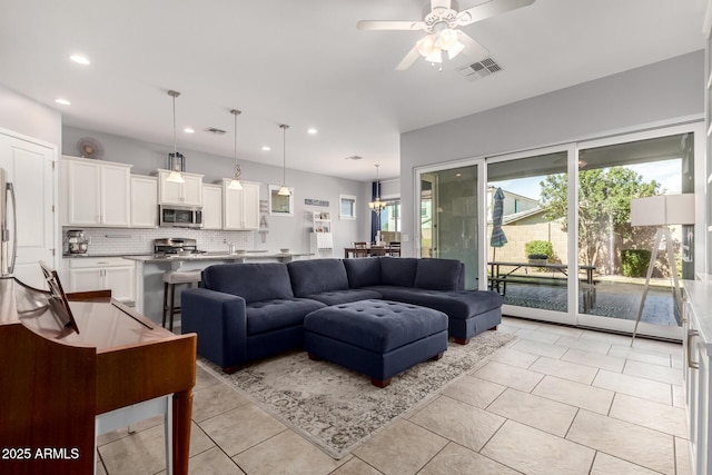 living room with light tile patterned floors, visible vents, recessed lighting, and ceiling fan