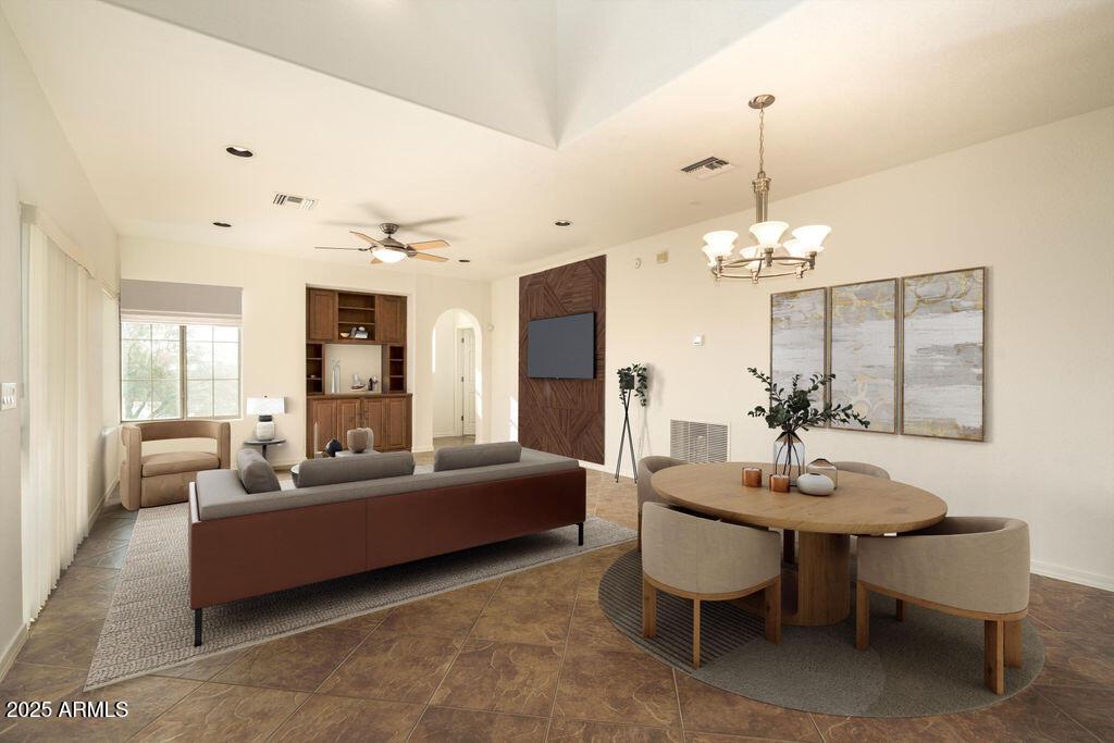 dining area featuring ceiling fan with notable chandelier