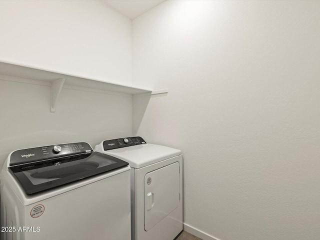 laundry room featuring laundry area, independent washer and dryer, and baseboards