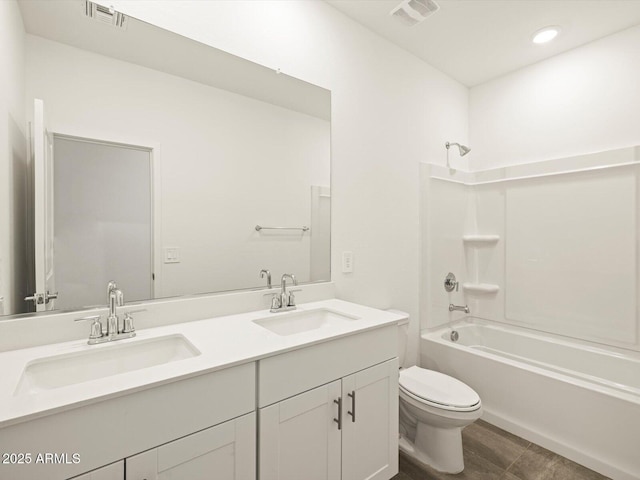 bathroom featuring visible vents, shower / washtub combination, and a sink