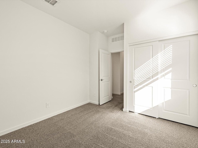 unfurnished bedroom with visible vents, baseboards, and carpet flooring