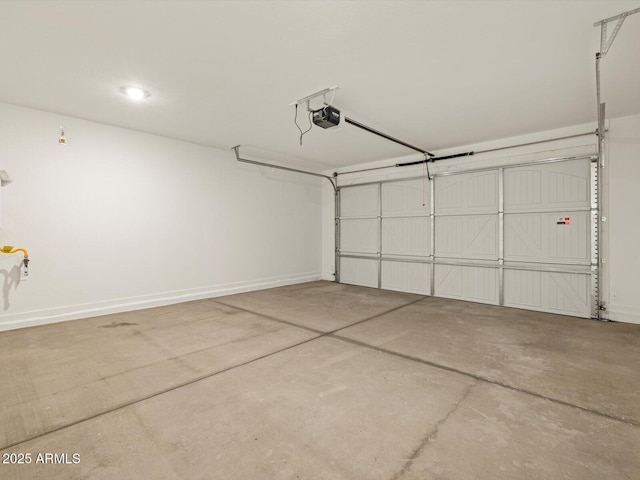 garage with baseboards and a garage door opener