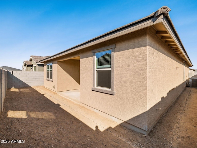 view of property exterior featuring a fenced backyard and stucco siding