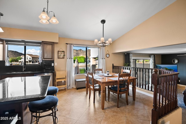 20657 N 56th Ave, Glendale, AZ 85308 - dining space with a chandelier, light tile patterned flooring, and vaulted ceiling