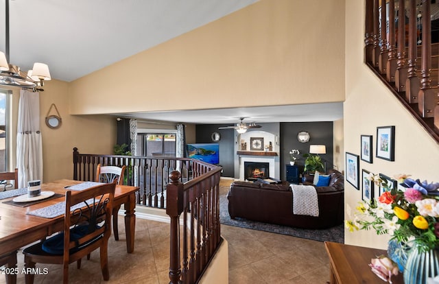 20657 N 56th Ave, Glendale, AZ 85308 - dining room featuring a lit fireplace, tile patterned flooring, ceiling fan, and high vaulted ceiling