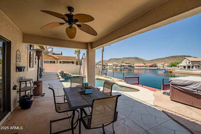 20657 N 56th Ave, Glendale, AZ 85308 - fenced backyard featuring a hot tub, a patio area, ceiling fan, a water and mountain view, and outdoor dining area