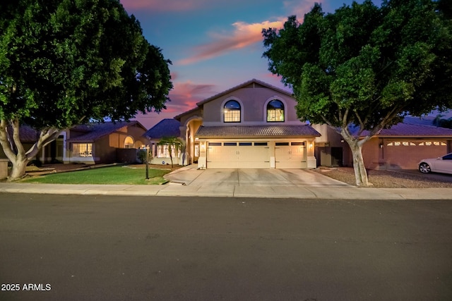20657 N 56th Ave, Glendale, AZ 85308 - view of front facade with a garage, concrete driveway, stucco siding, a tile roof, and a front yard