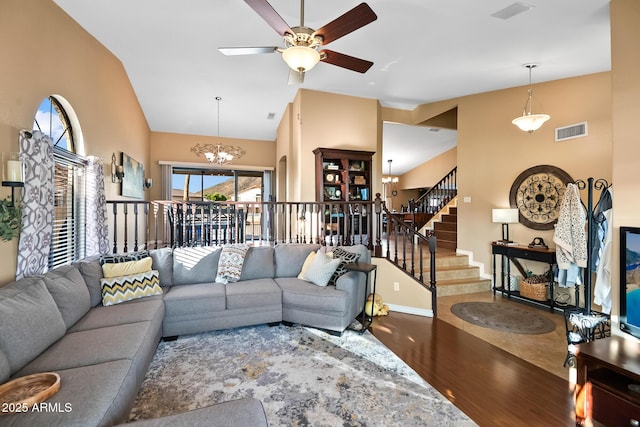 20657 N 56th Ave, Glendale, AZ 85308 - living area with wood finished floors, a chandelier, a ceiling fan, high vaulted ceiling, and stairway