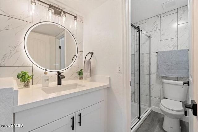 623 W Guadalupe Rd Unit 288, Mesa, AZ 85210 - bathroom with toilet, vanity, a stall shower, and wood finished floors