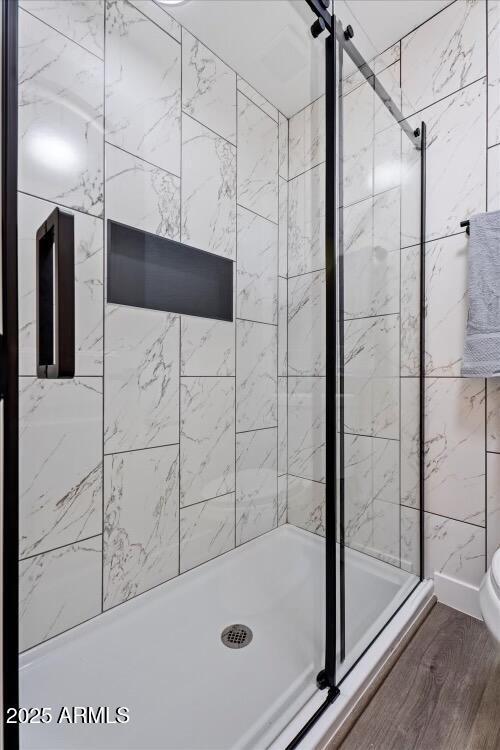 623 W Guadalupe Rd Unit 288, Mesa, AZ 85210 - full bathroom with a stall shower, toilet, and wood finished floors