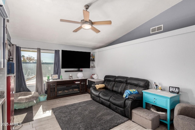 living room featuring vaulted ceiling and ceiling fan