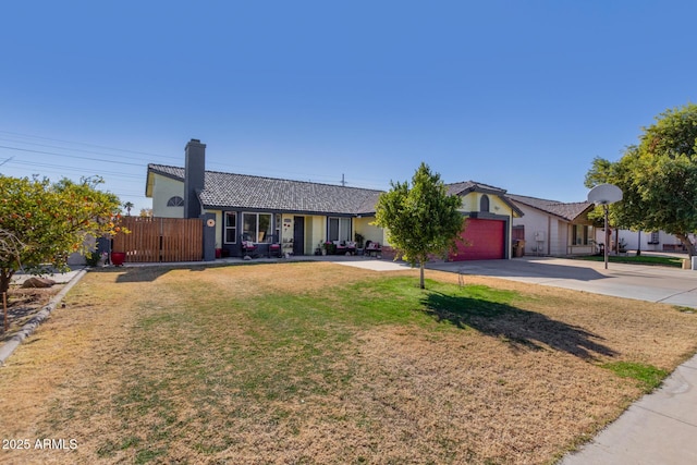 single story home with a garage and a front lawn