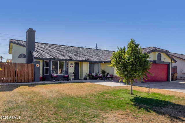 single story home featuring a garage and a front yard