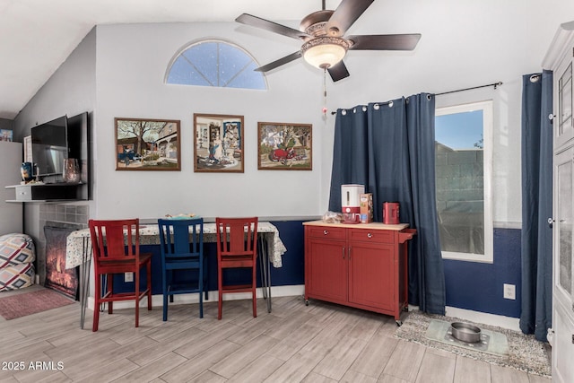 dining area featuring ceiling fan, vaulted ceiling, and plenty of natural light